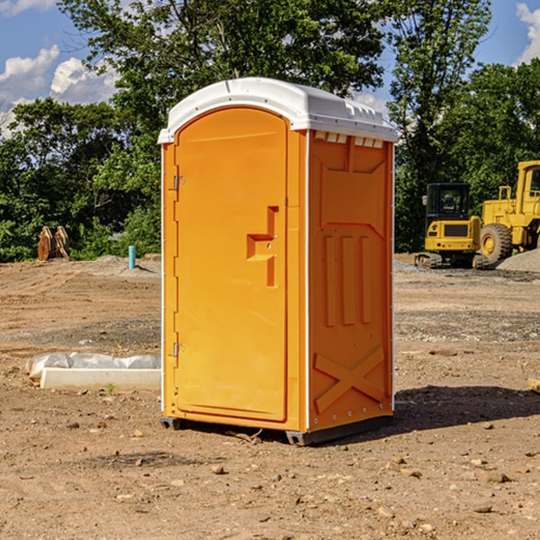 what is the cost difference between standard and deluxe portable restroom rentals in Rudyard